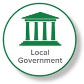Logo featuring a green and white design with an icon of a classical building and the text "Local Government" encircled by a green border.